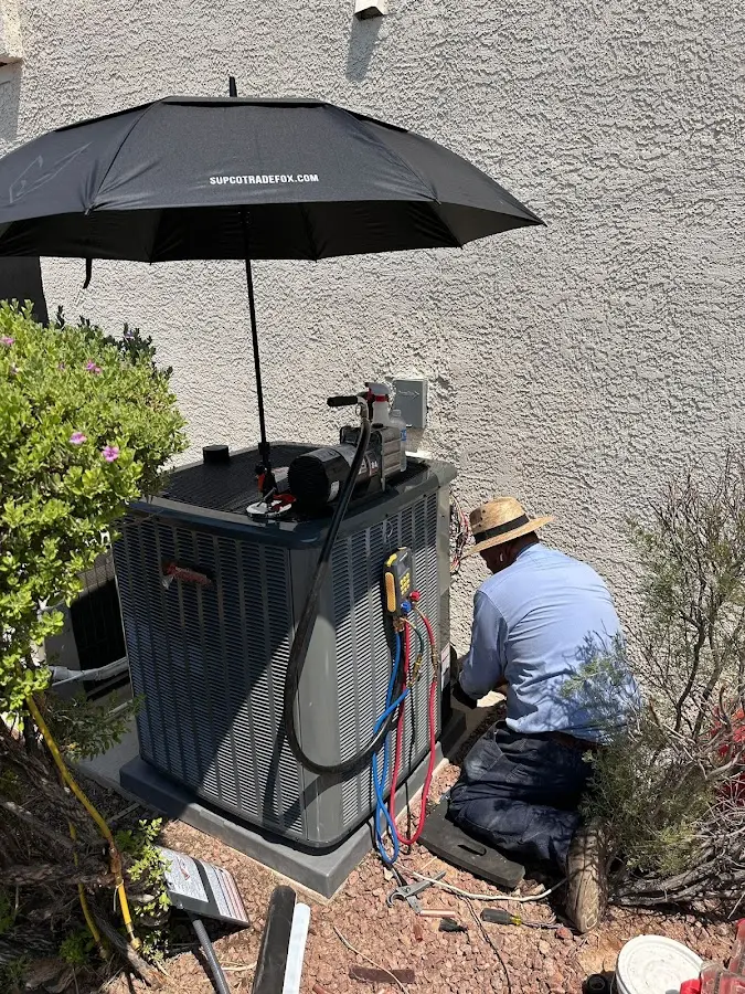 HVAC technician performing outdoor AC maintenance in Wabash